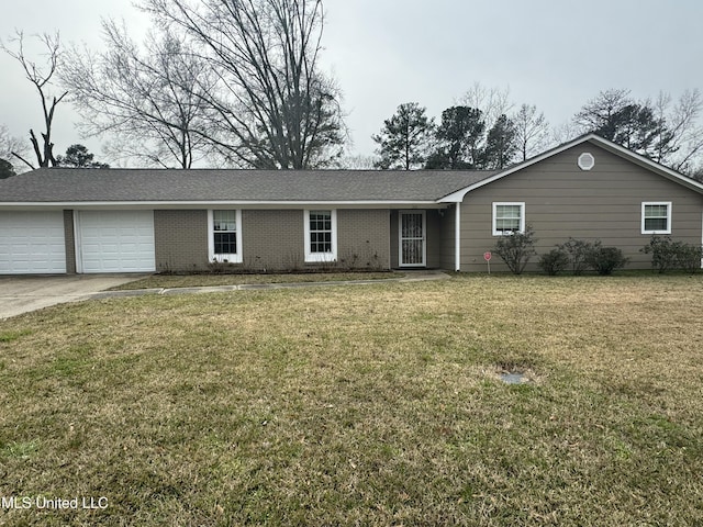 ranch-style house featuring a garage and a front lawn