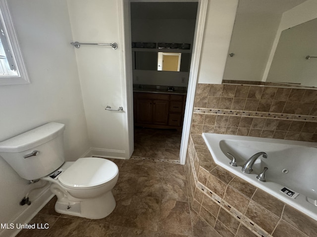 bathroom featuring tiled bath, toilet, and vanity