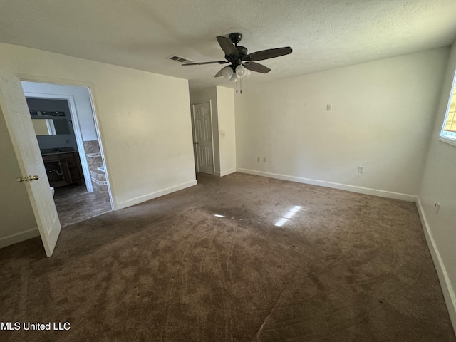 carpeted empty room featuring a textured ceiling and ceiling fan