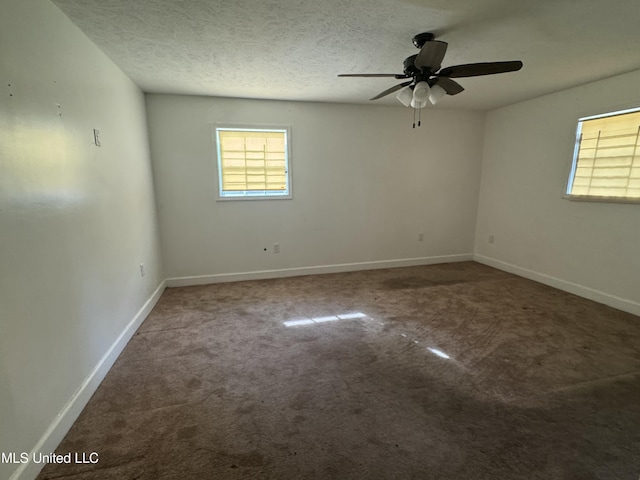 spare room featuring ceiling fan, a textured ceiling, and carpet flooring