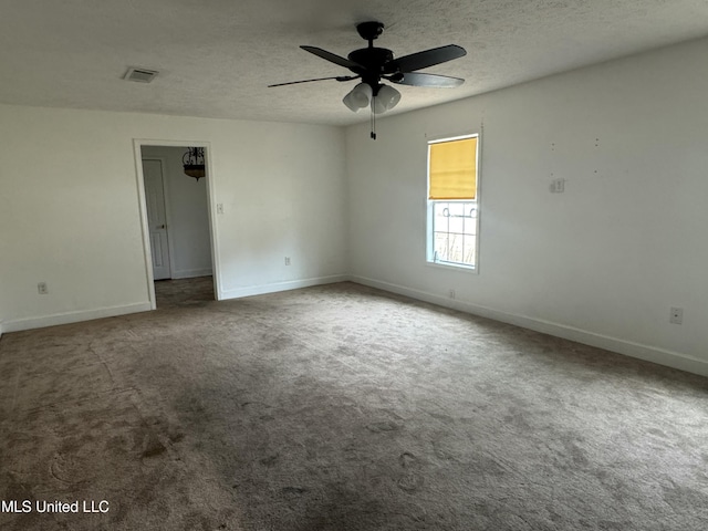 spare room featuring carpet, ceiling fan, and a textured ceiling