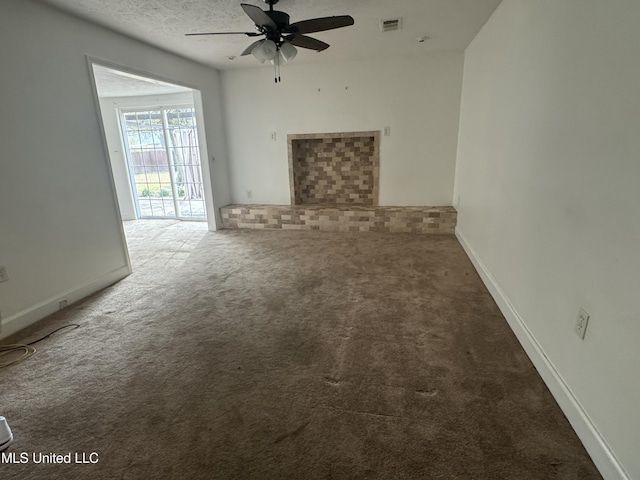 unfurnished living room with ceiling fan, a textured ceiling, and carpet flooring