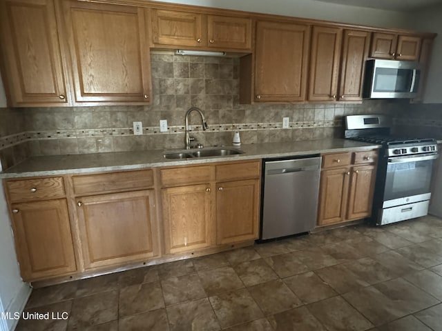 kitchen featuring backsplash, sink, and stainless steel appliances