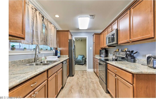 506 Loposser Ave, Gulfport, MS 39507 - kitchen featuring stainless steel appliances, a sink, brown cabinets, light wood-style floors, and ornamental molding