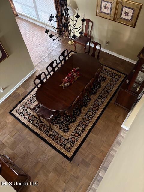 dining area with baseboards and an inviting chandelier