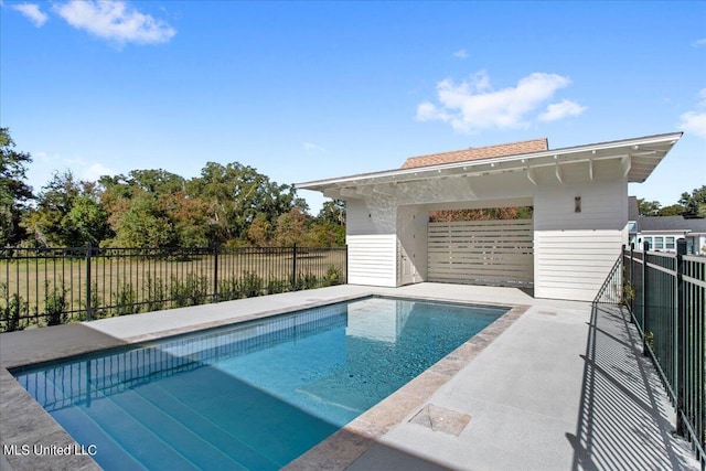 view of swimming pool featuring fence