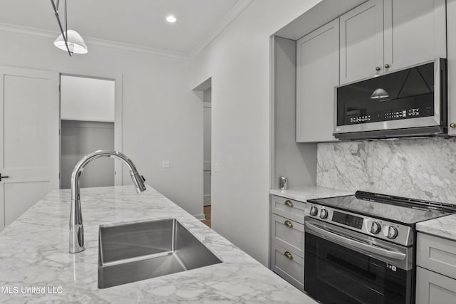 kitchen with stainless steel appliances, tasteful backsplash, ornamental molding, light stone countertops, and a sink