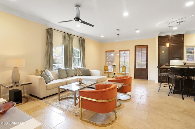 living room with ceiling fan and crown molding