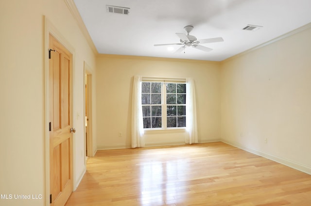 unfurnished room with light hardwood / wood-style floors, ceiling fan, and ornamental molding