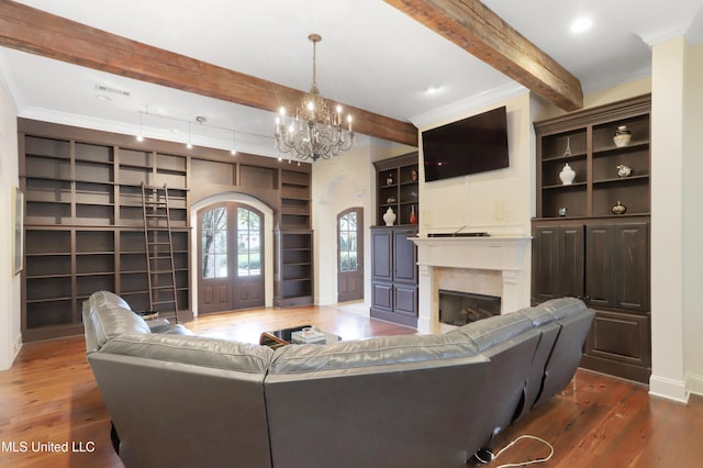 living room with beam ceiling, dark hardwood / wood-style floors, french doors, and ornamental molding