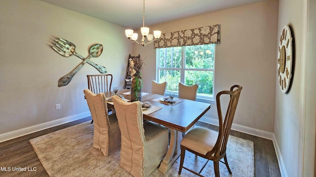 dining space with dark hardwood / wood-style flooring and a chandelier