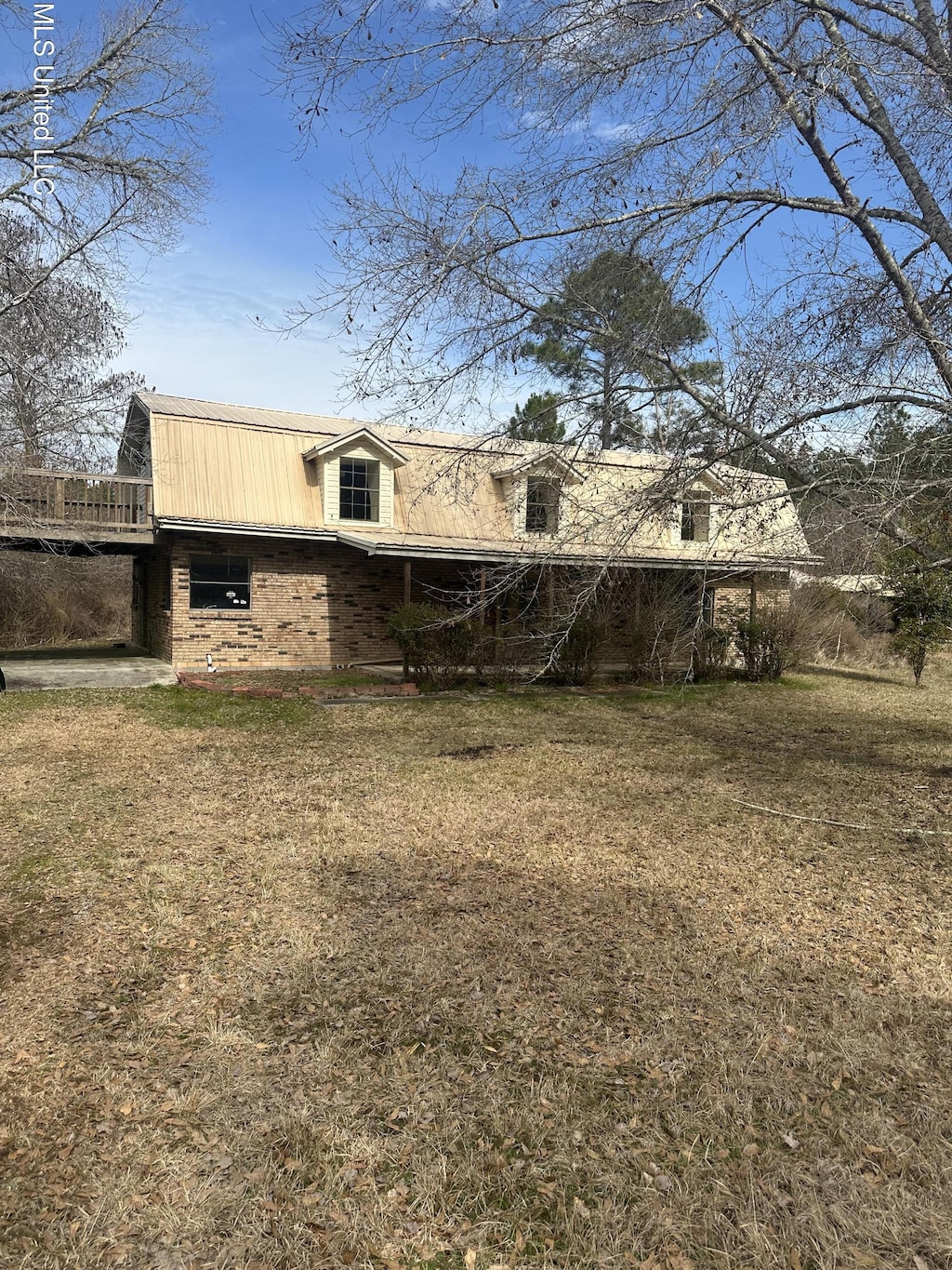 rear view of property with a lawn