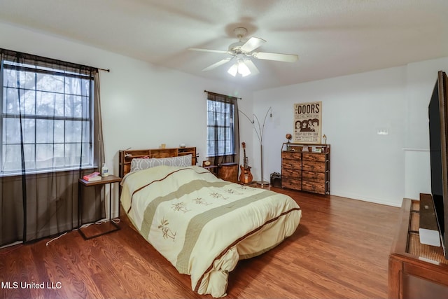 bedroom featuring a ceiling fan and wood finished floors