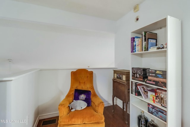 living area with wood finished floors and visible vents