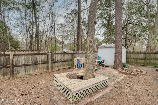 view of yard with an outbuilding, a storage shed, and a fenced backyard