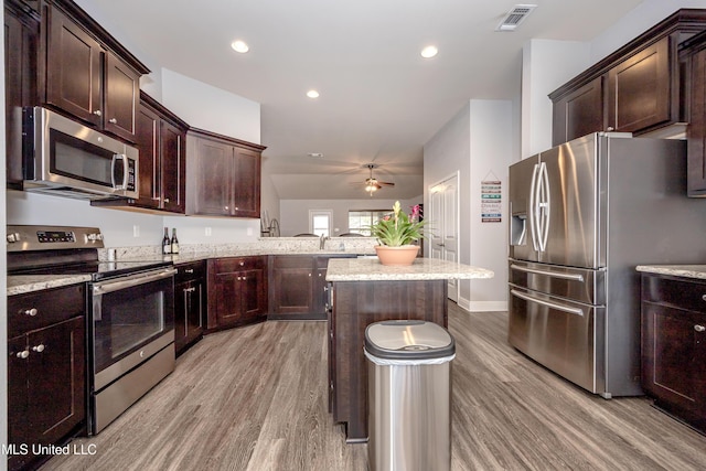 kitchen with visible vents, appliances with stainless steel finishes, light wood-style floors, and ceiling fan