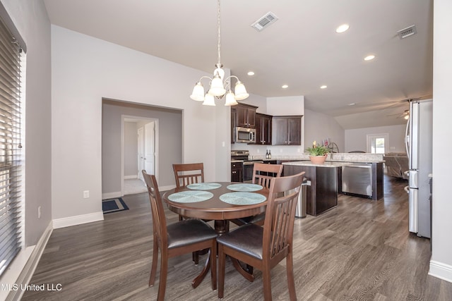 dining area featuring recessed lighting, visible vents, ceiling fan with notable chandelier, and dark wood-type flooring