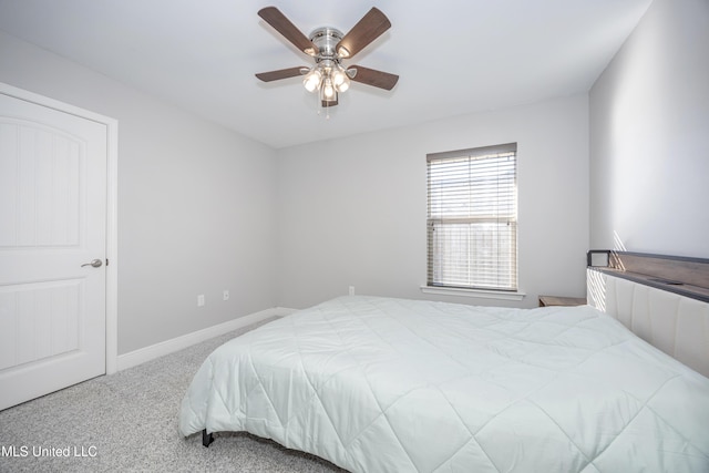 carpeted bedroom with a ceiling fan and baseboards