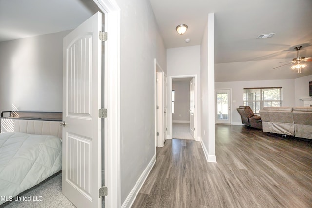 bedroom with visible vents, baseboards, and wood finished floors