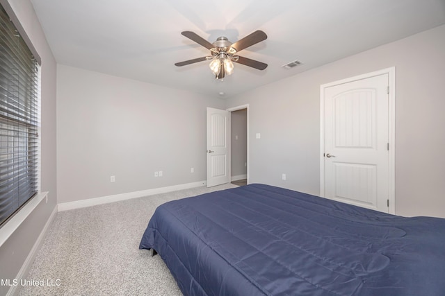 carpeted bedroom with visible vents, baseboards, and ceiling fan