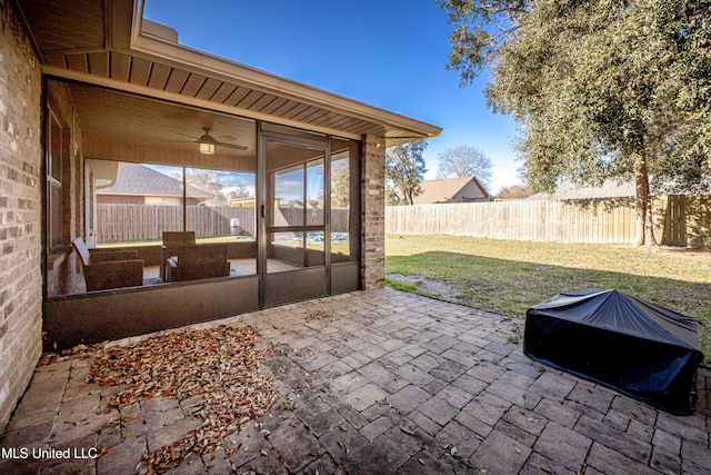 view of patio with a fenced backyard and a sunroom