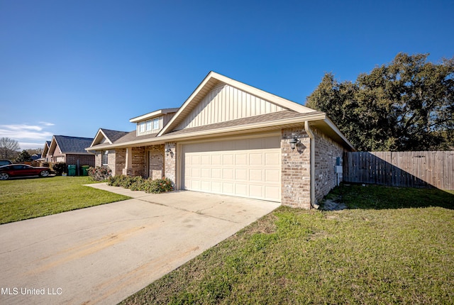 view of front of house with a front yard, fence, driveway, a garage, and brick siding