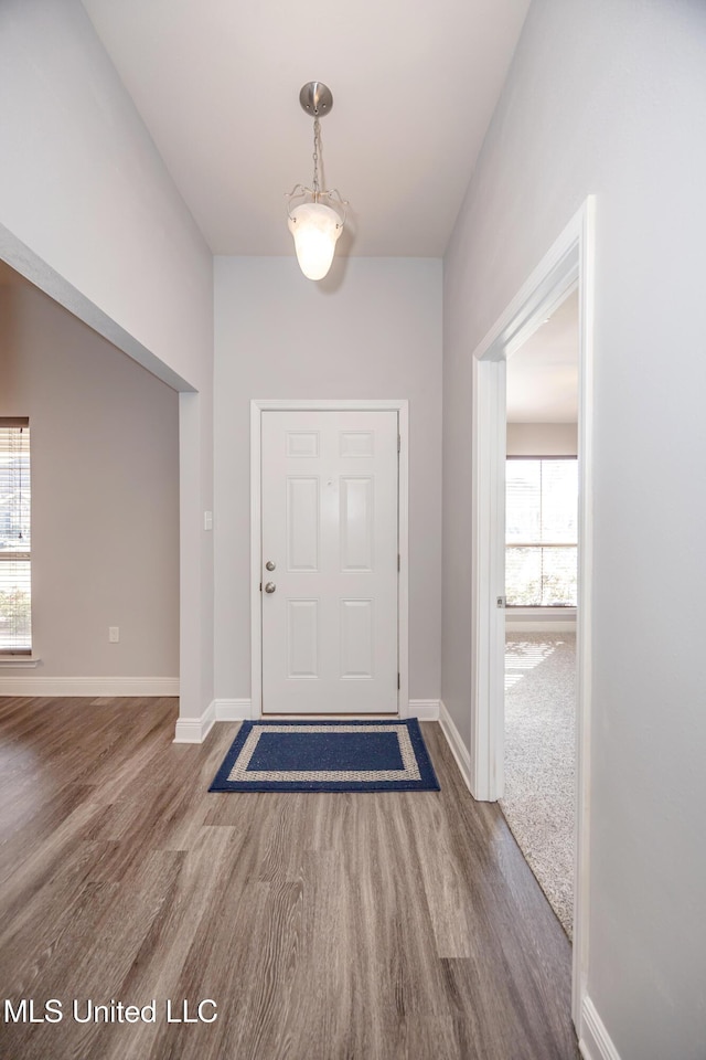 entryway with baseboards, plenty of natural light, and wood finished floors