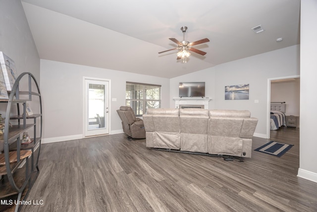 living room with visible vents, baseboards, ceiling fan, lofted ceiling, and dark wood-style floors