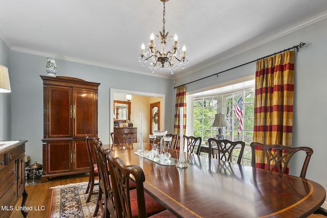 dining room with ornamental molding, dark hardwood / wood-style flooring, and a chandelier