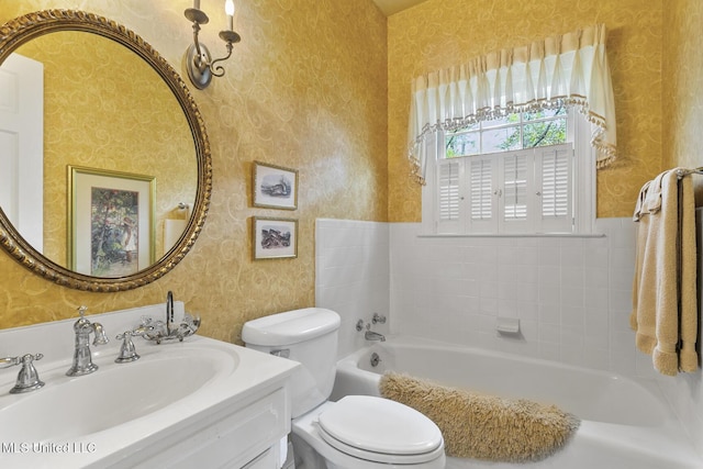 bathroom with a bathing tub, vanity, and toilet