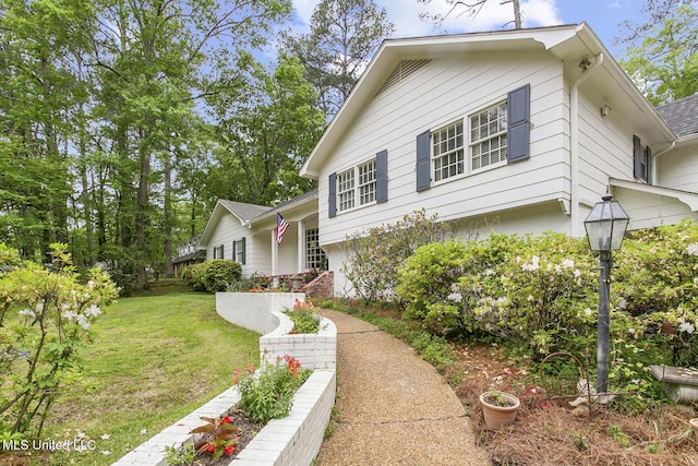 tri-level home with a front yard