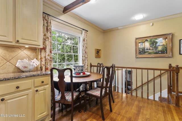 dining space featuring ornamental molding and dark hardwood / wood-style flooring