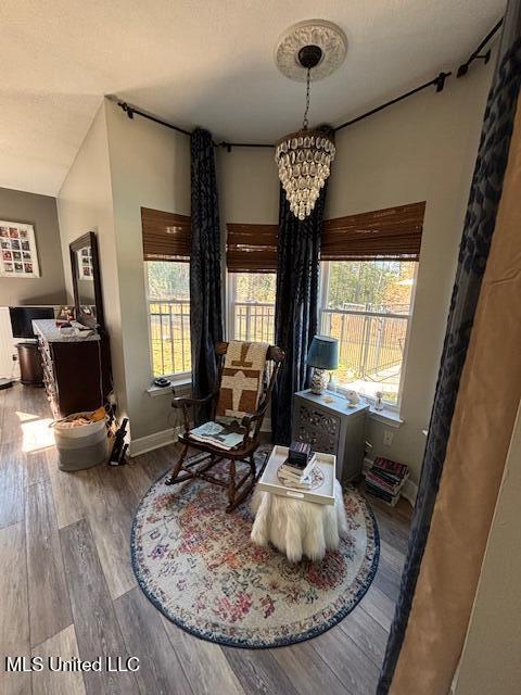 sitting room with a chandelier, hardwood / wood-style floors, and a textured ceiling