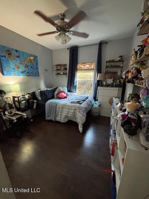 bedroom featuring dark hardwood / wood-style flooring and ceiling fan