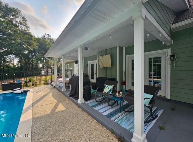 view of pool with a patio and a grill