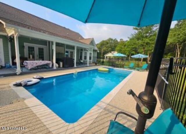 view of swimming pool with a patio area