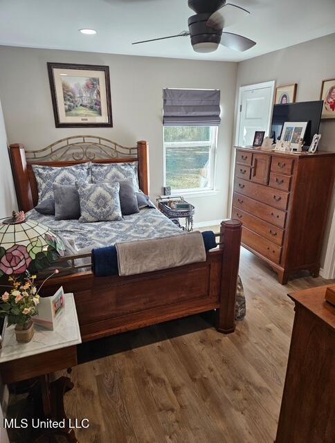 bedroom with hardwood / wood-style floors and ceiling fan