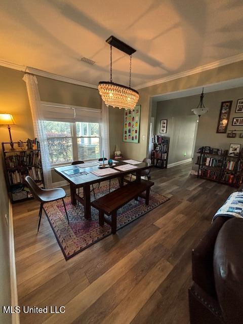 dining space featuring crown molding and wood-type flooring