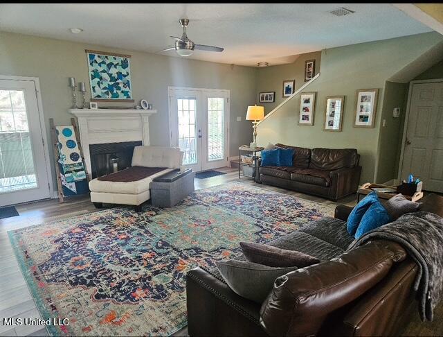 living room with wood-type flooring and french doors