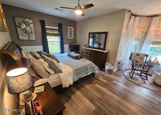 bedroom featuring wood-type flooring and ceiling fan