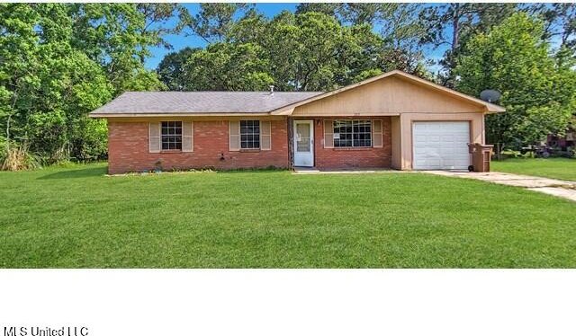 205 Shalimar Dr, Long Beach, MS 39560 - ranch-style home featuring a garage, concrete driveway, and a front yard