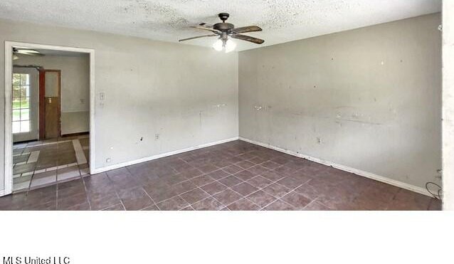 205 Shalimar Dr, Long Beach, MS 39560 - spare room with ceiling fan, baseboards, and a textured ceiling