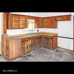 205 Shalimar Dr, Long Beach, MS 39560 - kitchen with brown cabinets, freestanding refrigerator, and light countertops