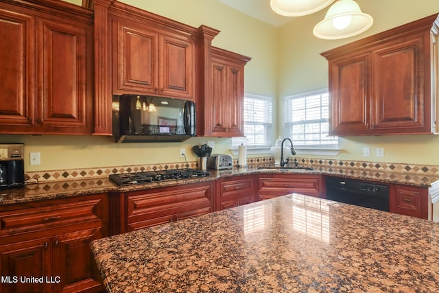 kitchen with sink, dark stone counters, and black appliances