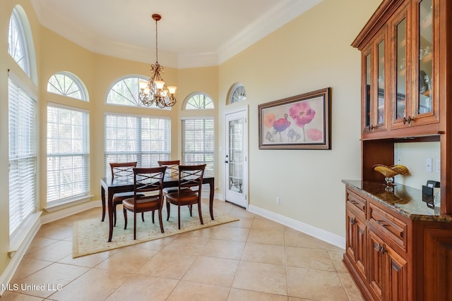 dining space featuring crown molding, a healthy amount of sunlight, and light tile patterned flooring