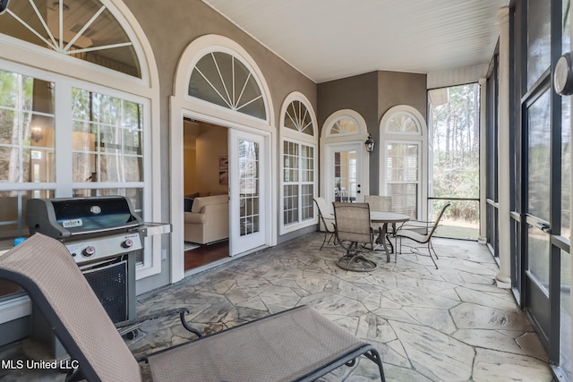 sunroom / solarium featuring french doors