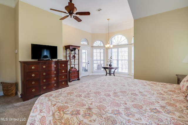 carpeted bedroom featuring access to outside and an inviting chandelier