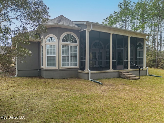 exterior space with a yard and a sunroom