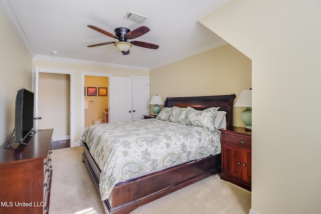 carpeted bedroom with ensuite bath, ornamental molding, a closet, and ceiling fan