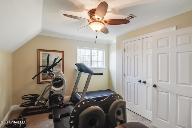 exercise area with ceiling fan, vaulted ceiling, and light carpet